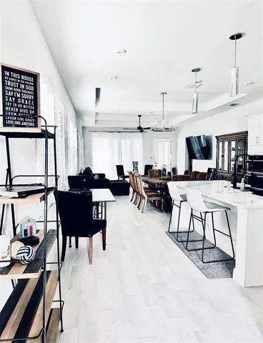 a view of a kitchen with a sink and a chandelier
