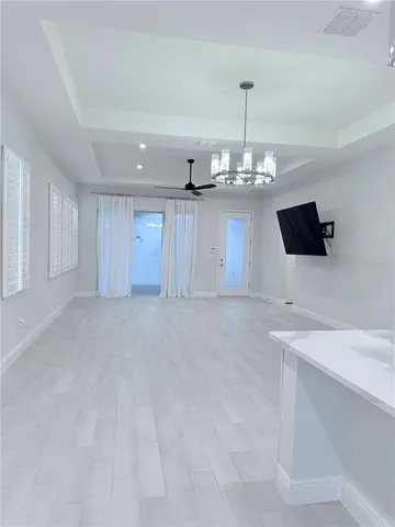 a view of a kitchen with a sink and a chandelier