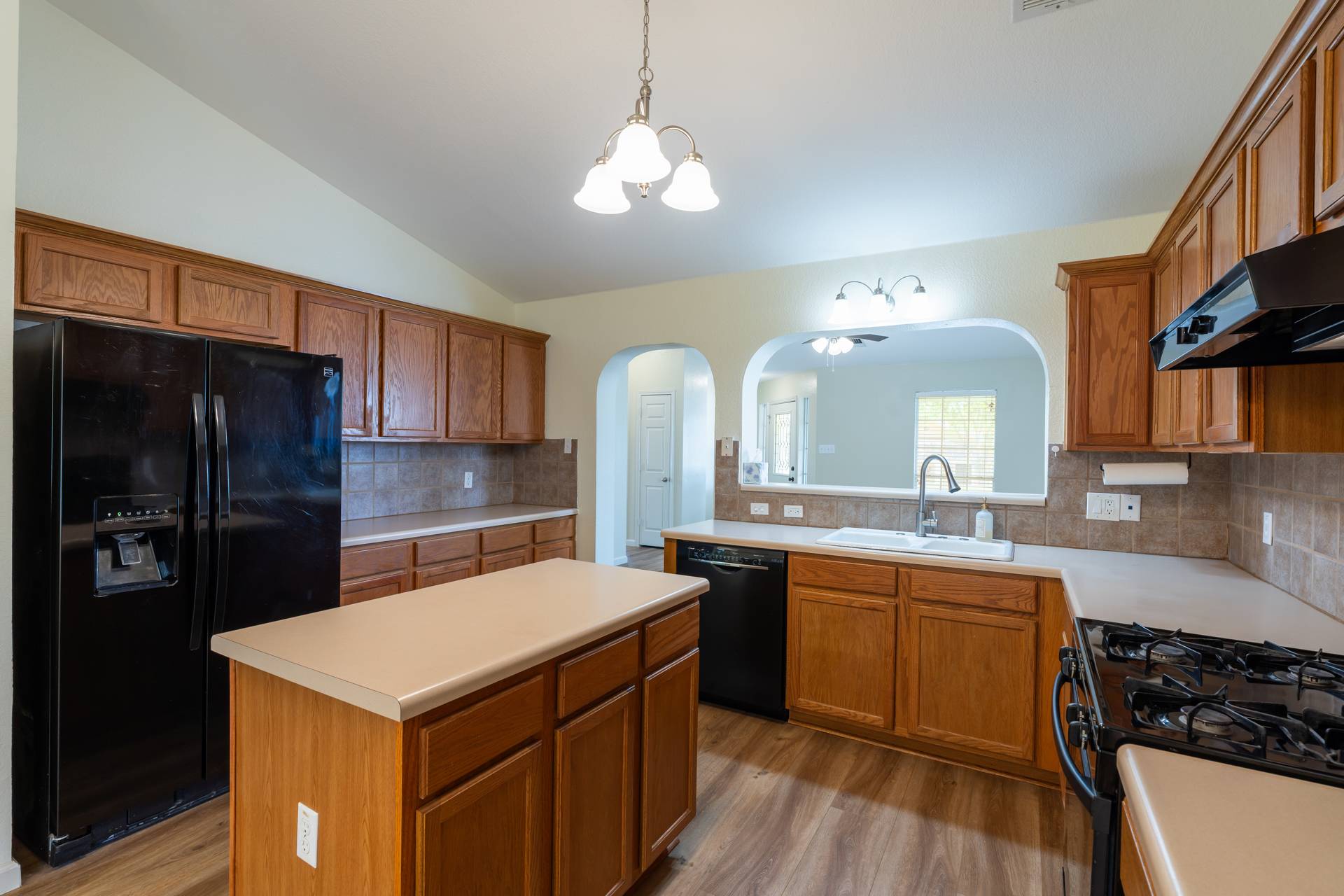 5911 Steiner Kyle, TX 78640 - Photo 11 of 36 a kitchen with a sink a stove and cabinets