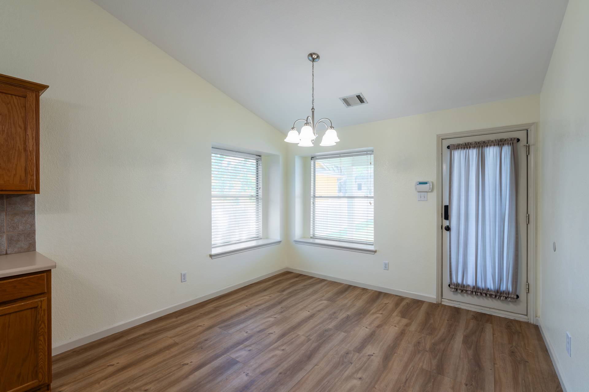 5911 Steiner Kyle, TX 78640 - Photo 13 of 36 a view of an empty room with wooden floor and a window