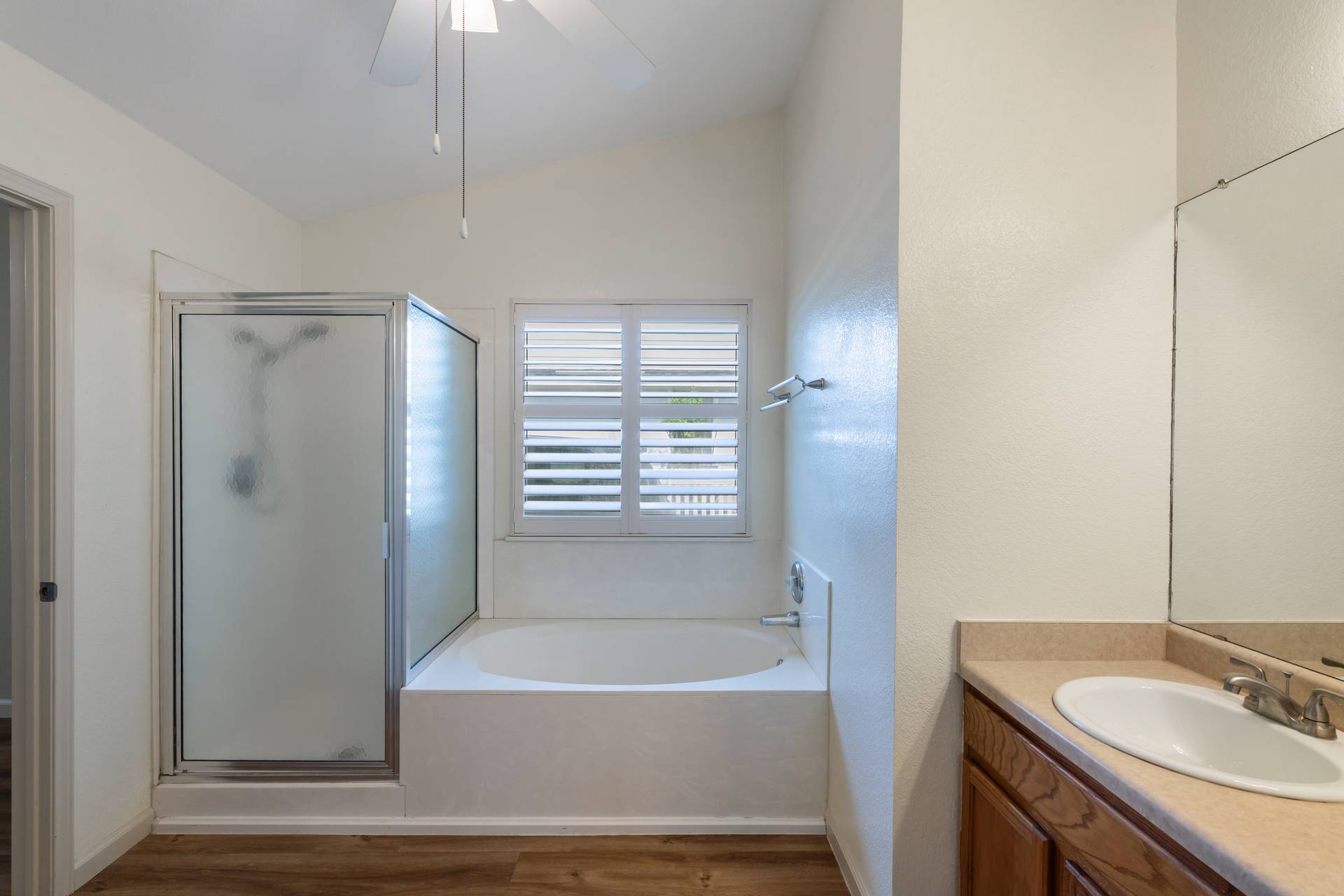 5911 Steiner Kyle, TX 78640 - Photo 17 of 36 a bathroom with a tub sink vanity and a mirror