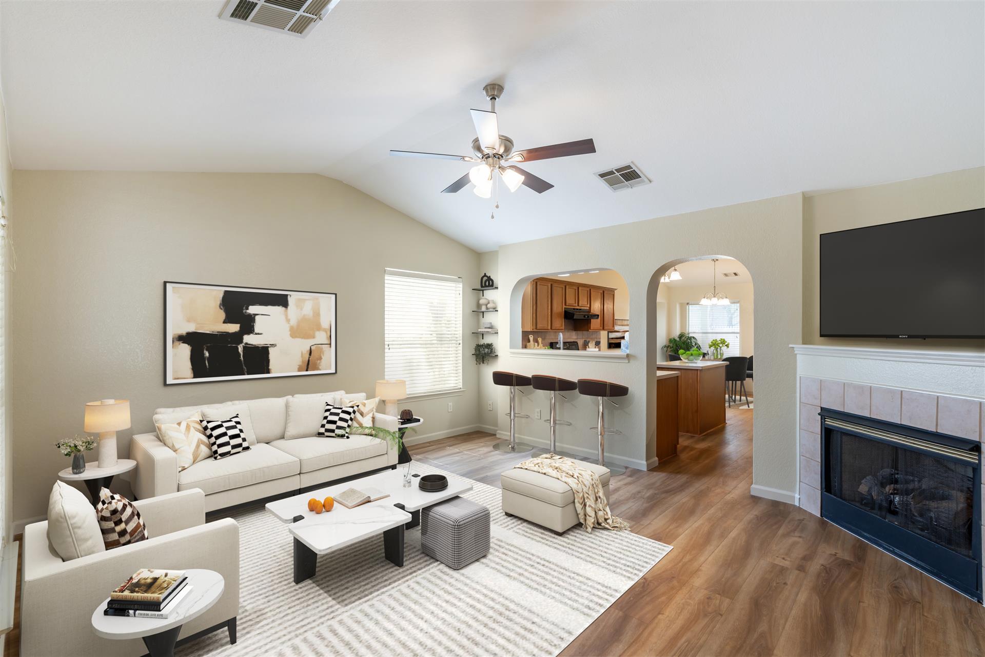5911 Steiner Kyle, TX 78640 - Photo 2 of 36 a living room with furniture a fireplace and a flat screen tv