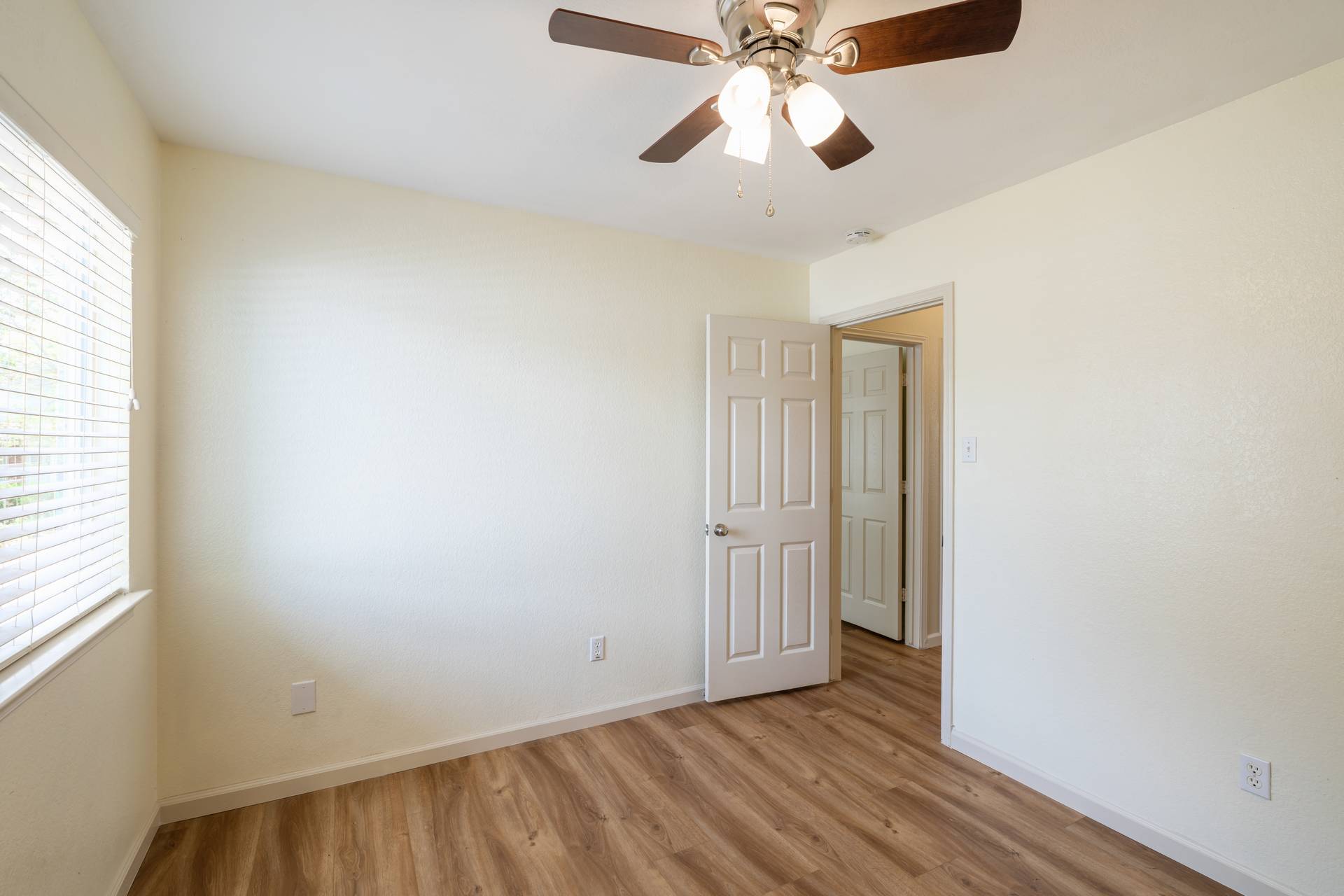 5911 Steiner Kyle, TX 78640 - Photo 24 of 36 an empty room with wooden floor chandelier fan and windows