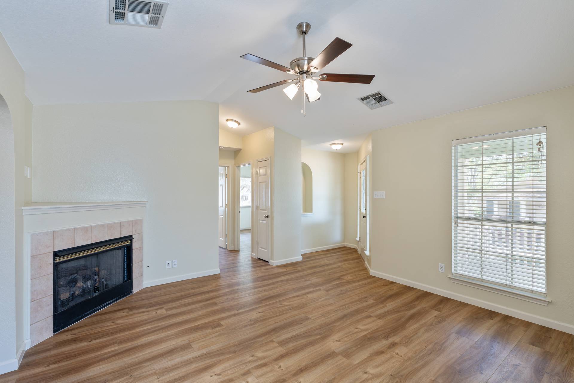 5911 Steiner Kyle, TX 78640 - Photo 10 of 36 a view of an empty room with a fireplace and a window