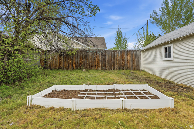 215 East 300 South Logan, UT 84321 - Photo 27 of 32 Fenced backyard with a vegetable garden