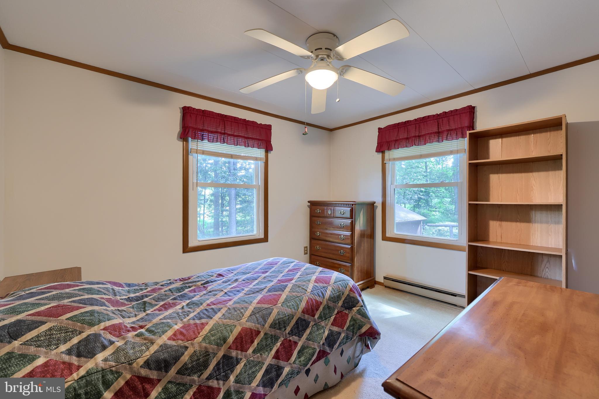 4664 Beards School Road Spring Grove, PA 17362 - Photo 25 of 50 a bedroom with a bed and a chandelier