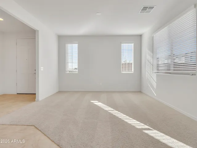 a large kitchen with stainless steel appliances kitchen island granite countertop a refrigerator and a sink