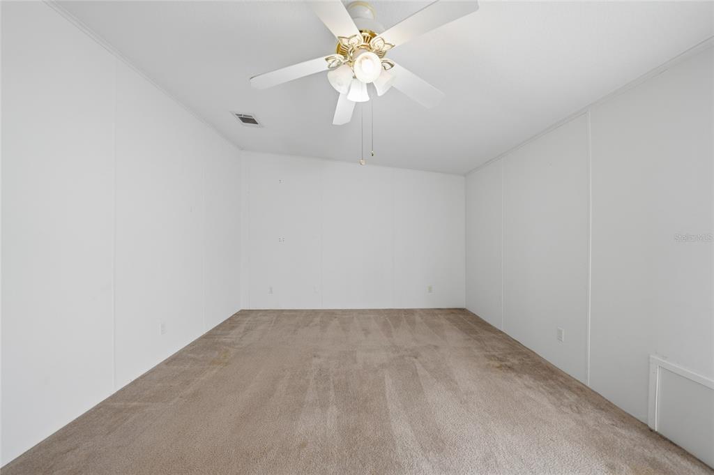 11923 Southwest Loop Terrace Arcadia, FL 34269 - Photo 15 of 50 an empty room with a window and a chandelier fan