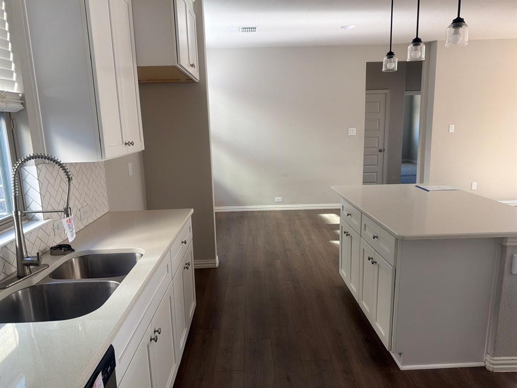 3936 Chesapeake Lane Forney, TX 75126 - Photo 11 of 40 a kitchen with a sink and refrigerator