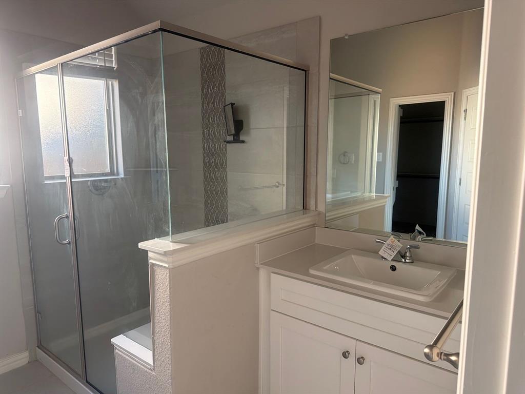 3936 Chesapeake Lane Forney, TX 75126 - Photo 22 of 40 a bathroom with a sink a toilet and shower