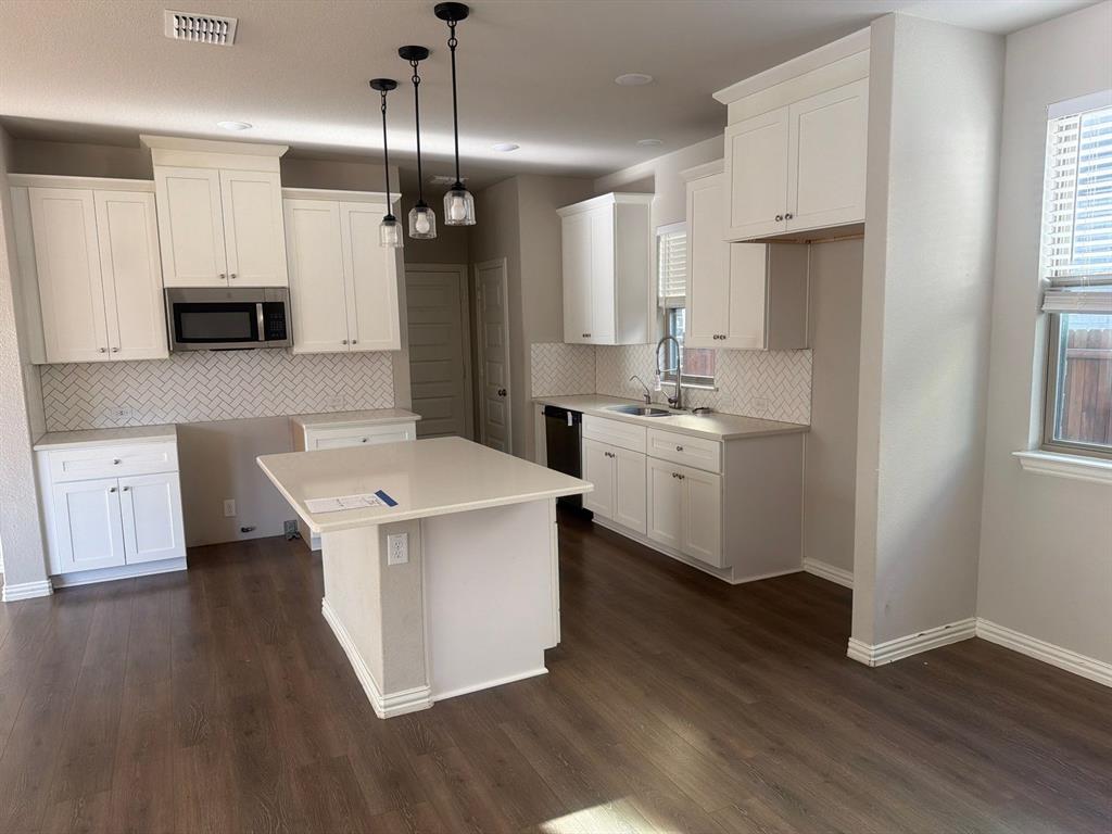 3936 Chesapeake Lane Forney, TX 75126 - Photo 6 of 40 a view of kitchen with stainless steel appliances a sink a window and wooden floor
