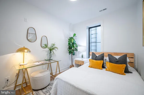 a bedroom with a bed a couch and dresser