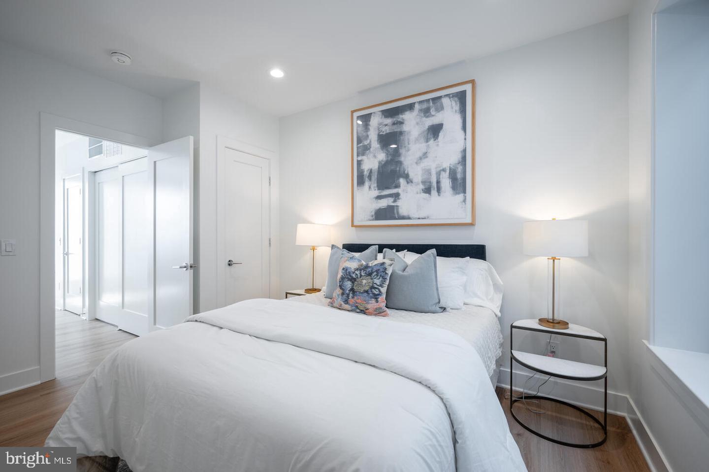 1228 Brentwood Road Northeast, Unit 1 Washington, DC 20018 - Photo 15 of 21 a bedroom with a bed and a painting on the wall