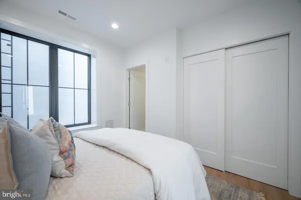 a bedroom with a bed and a window