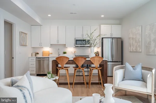 a living room with furniture a refrigerator and a dining table