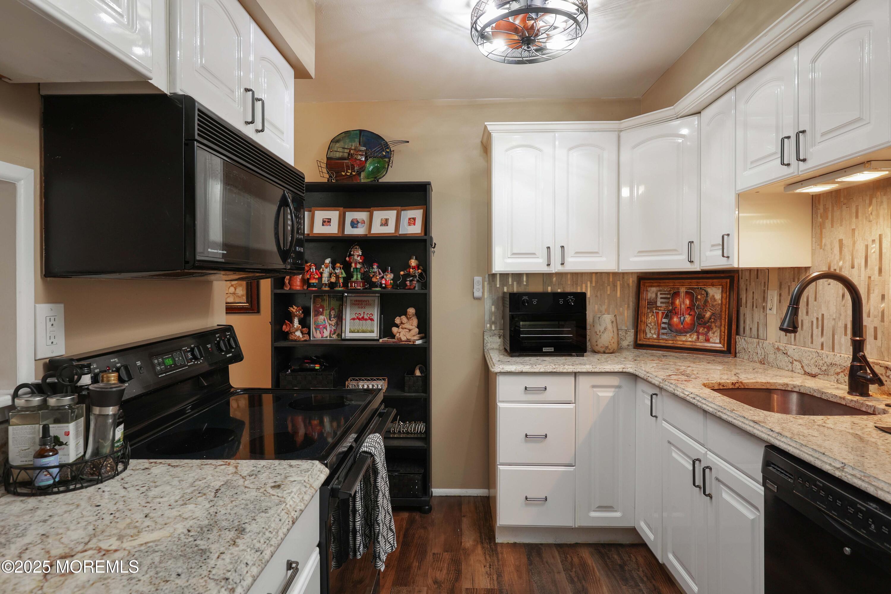 200 Portland Road, Unit D15 Highlands, NJ 07732 - Photo 12 of 56 a kitchen with stainless steel appliances granite countertop a stove a sink and a microwave