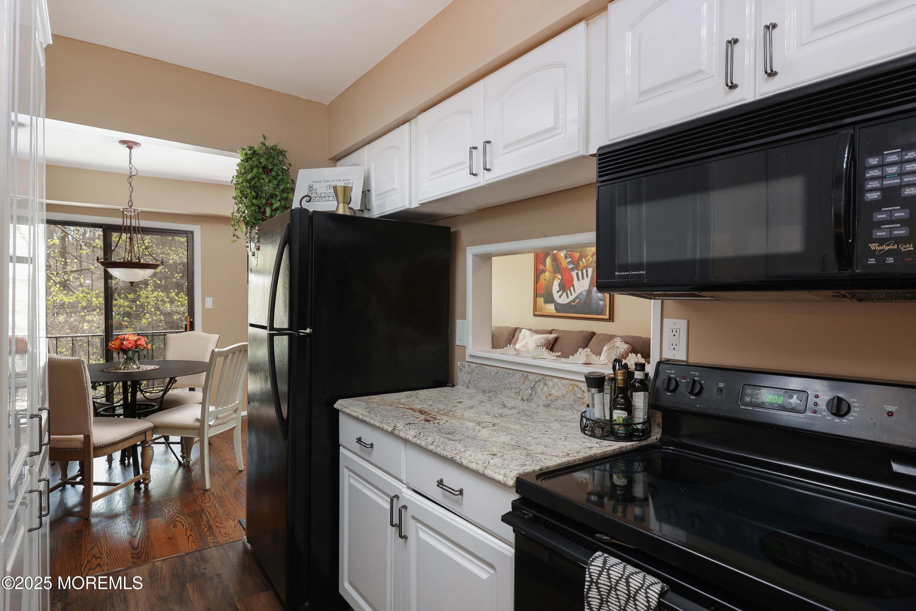 200 Portland Road, Unit D15 Highlands, NJ 07732 - Photo 14 of 56 a kitchen with a stove microwave and refrigerator