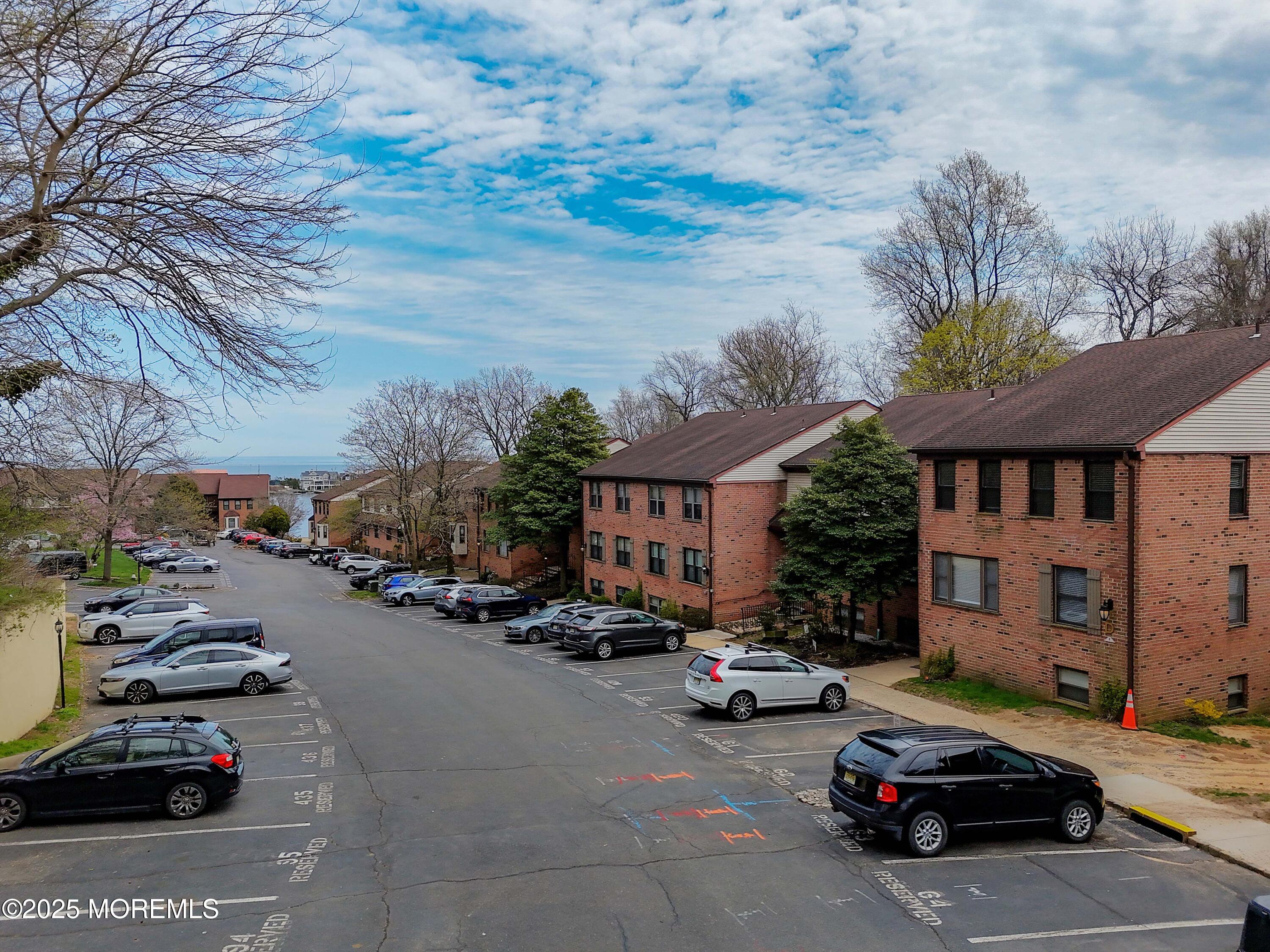 200 Portland Road, Unit D15 Highlands, NJ 07732 - Photo 7 of 56 a city street lined with parked cars and buildings