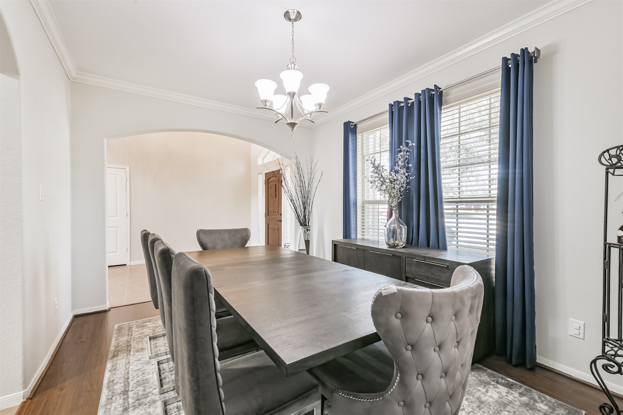 2602 Fort Settlement Trail Spring, TX 77373 - Photo 12 of 50 A sophisticated formal dining room featuring elegant crown molding, an arched entryway, and refined window treatments.