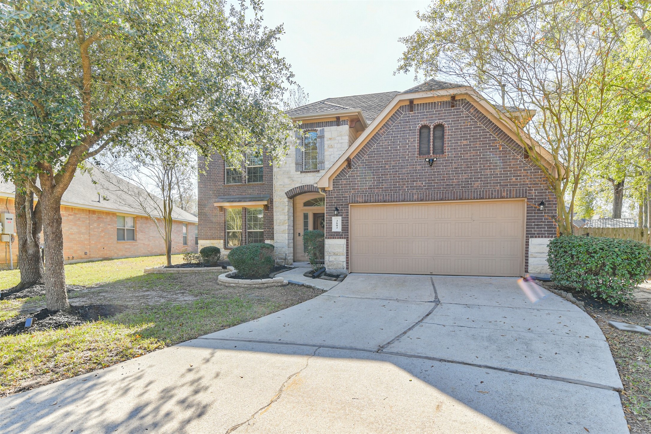 2602 Fort Settlement Trail Spring, TX 77373 - Photo 2 of 50 Spacious double-wide driveway, surrounded by mature trees and enhanced by lush landscaping.