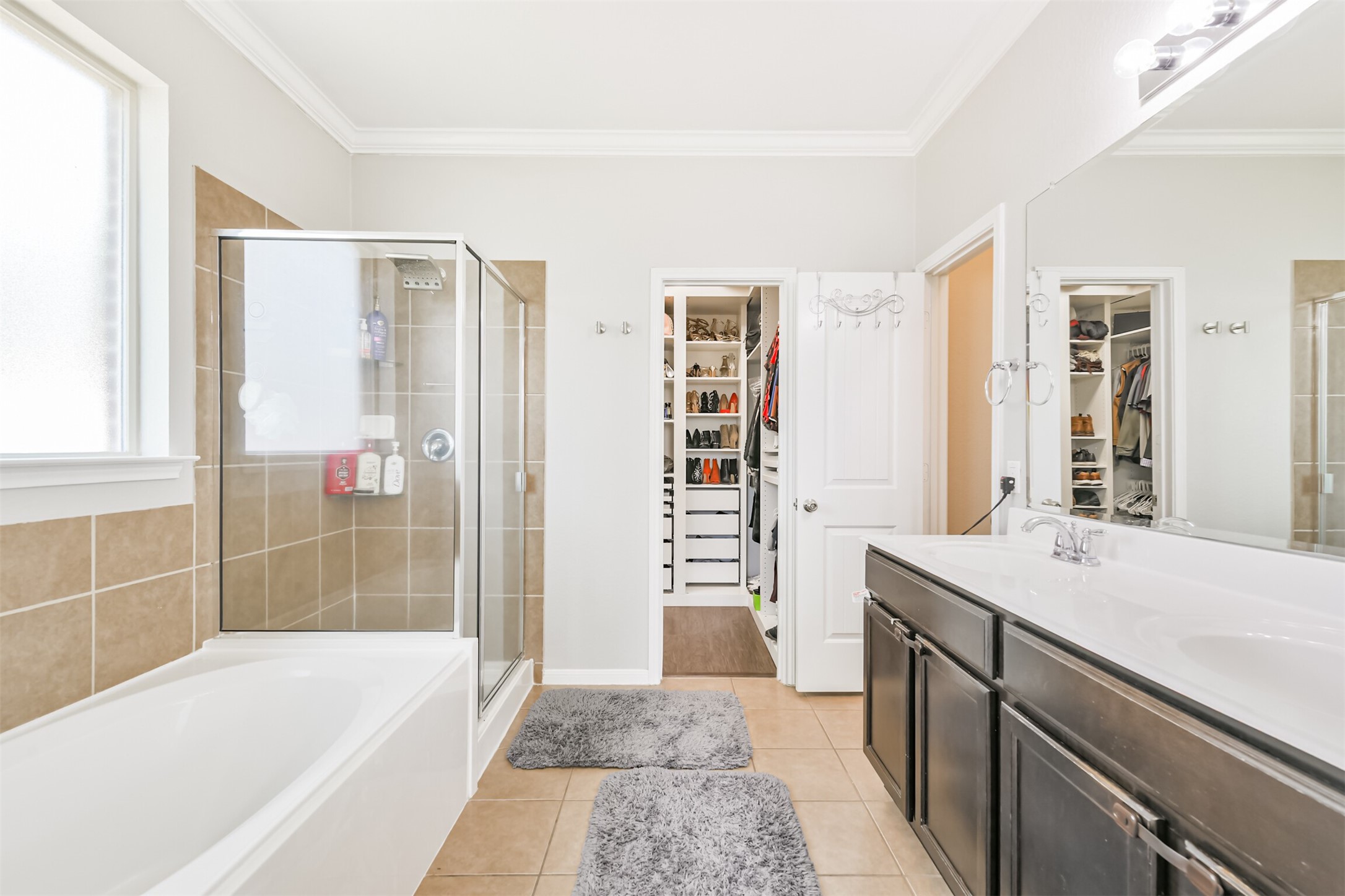 2602 Fort Settlement Trail Spring, TX 77373 - Photo 24 of 50 The primary bedroom boasts a luxurious soaker tub, a sleek walk-in glass-enclosed shower, and an elegant double-wing vanity.