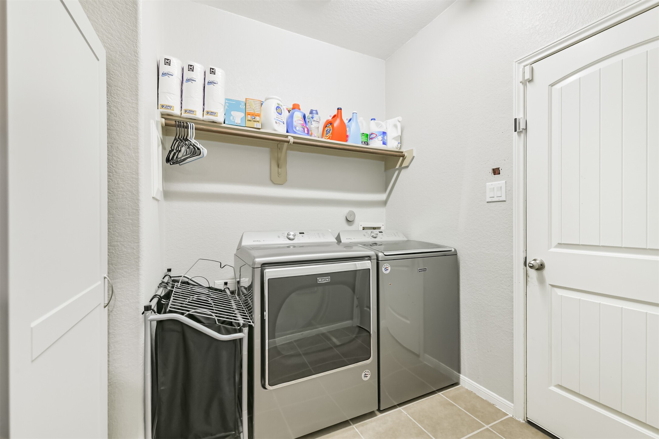 2602 Fort Settlement Trail Spring, TX 77373 - Photo 36 of 50 Downstairs, the utility room is equipped with a storage shelf and a wood dowel.