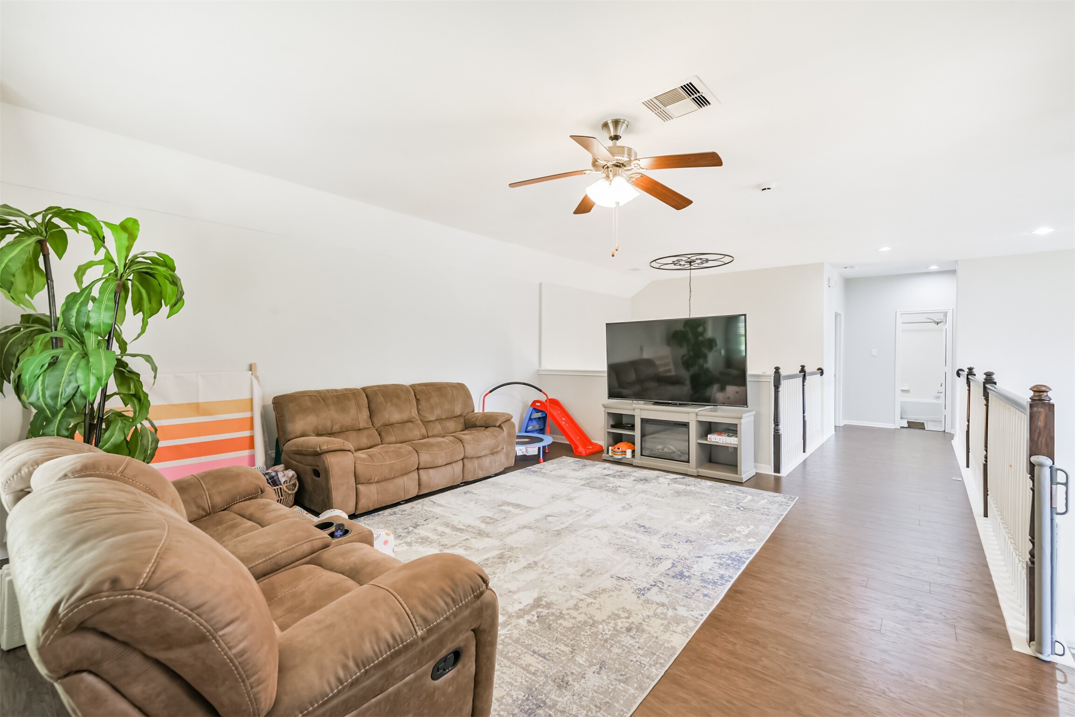 2602 Fort Settlement Trail Spring, TX 77373 - Photo 37 of 50 A generously sized game room awaits upstairs, complete with a ceiling fan and elegant light fixture for comfort and style.