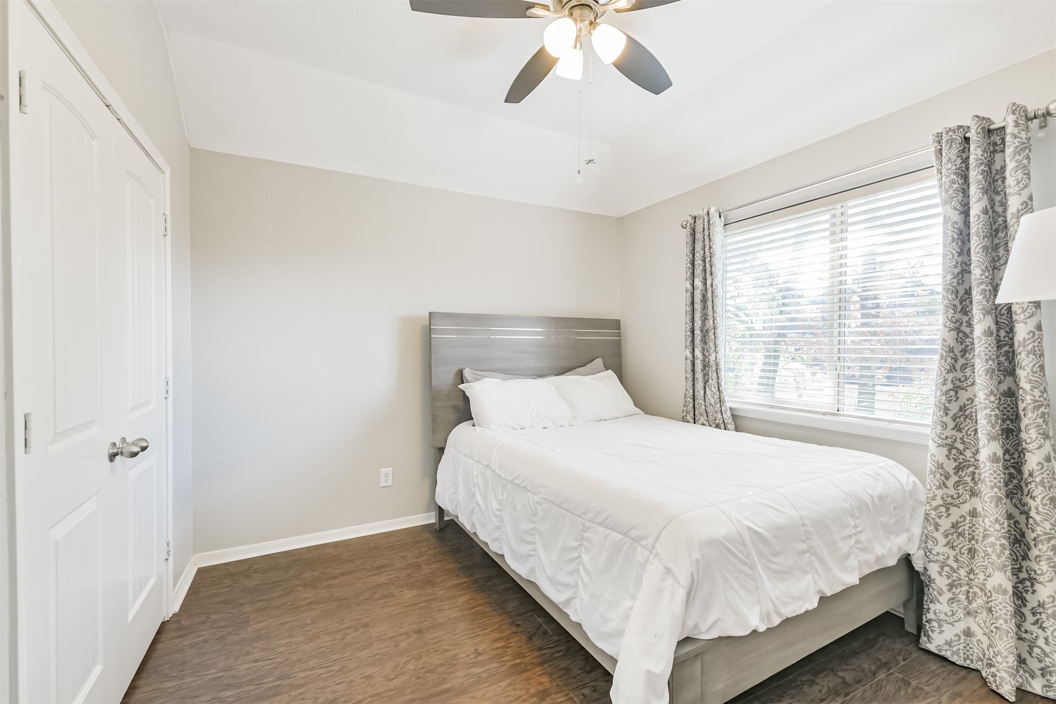 2602 Fort Settlement Trail Spring, TX 77373 - Photo 45 of 50 The fourth upstairs bedroom features a ceiling fan with a light fixture, elegant custom window treatments, and French doors that open to the closet.