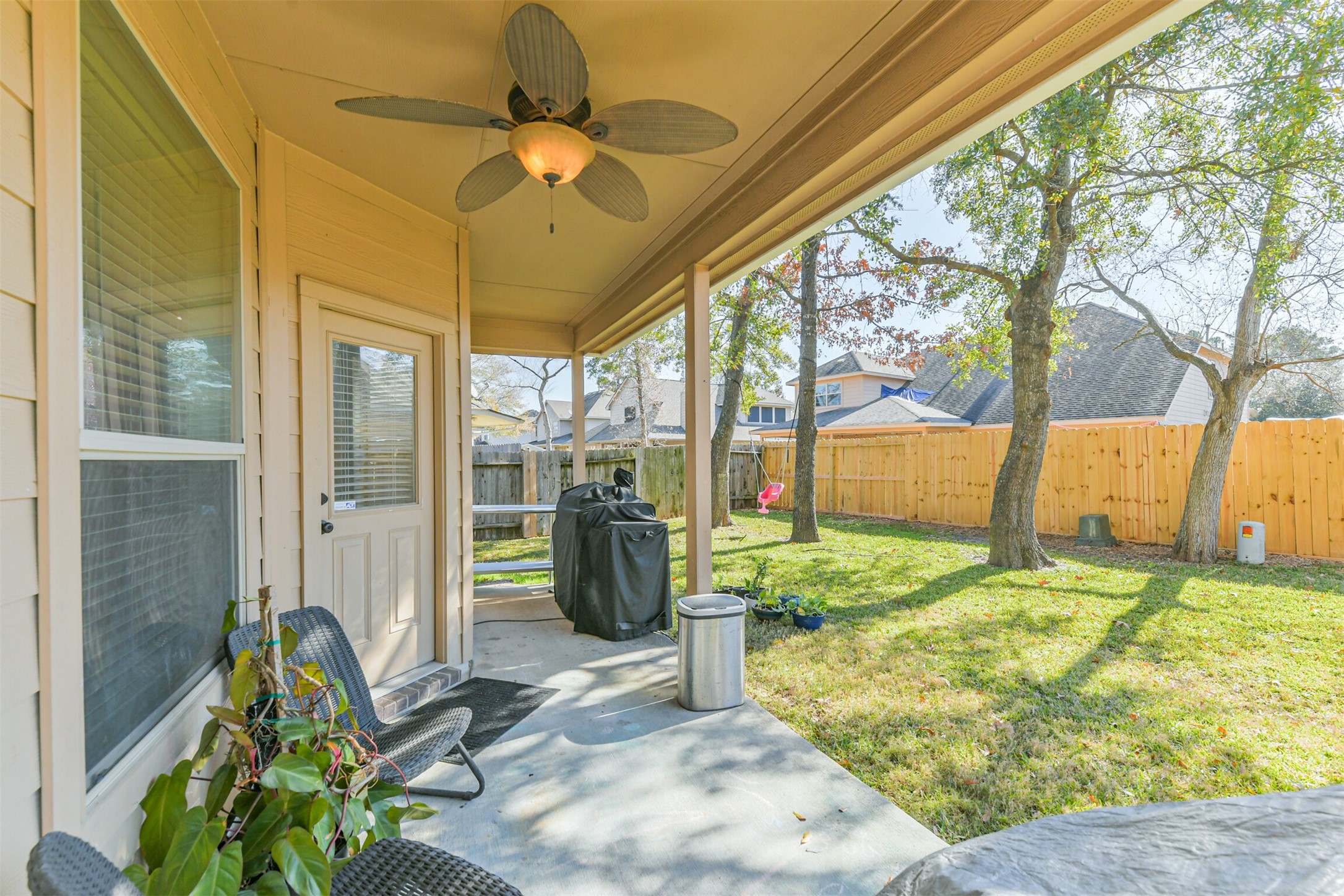2602 Fort Settlement Trail Spring, TX 77373 - Photo 48 of 50 Stay cool and comfortable on the covered patio, complete with a ceiling fan for added comfort. There's also plenty of room for outdoor grilling.