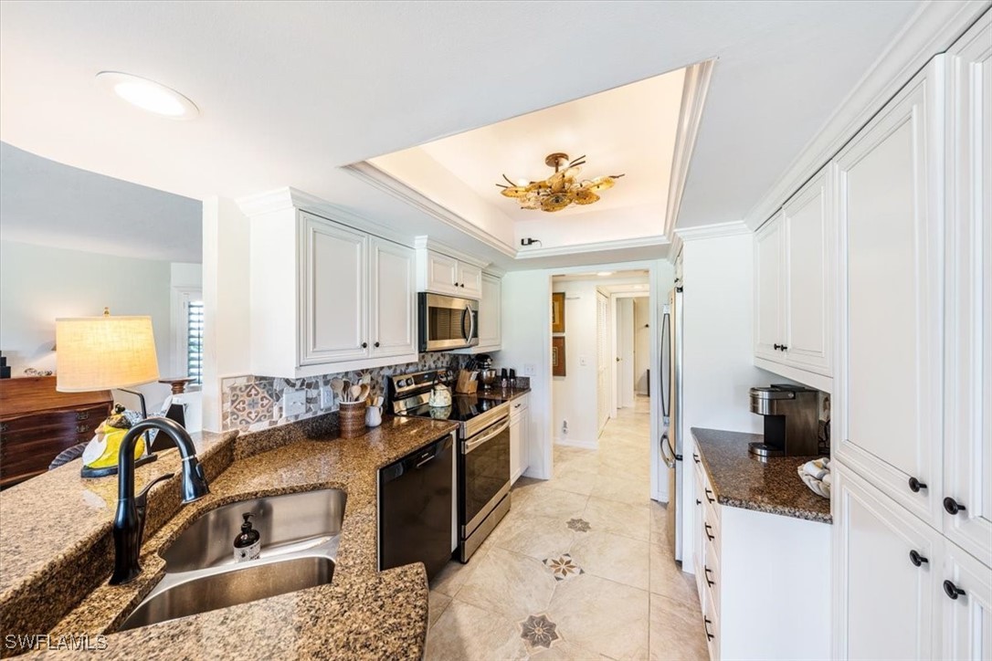 792 Eagle Creek Drive, Unit 101 Naples, FL 34113 - Photo 12 of 16 a living room with furniture and a flat screen tv