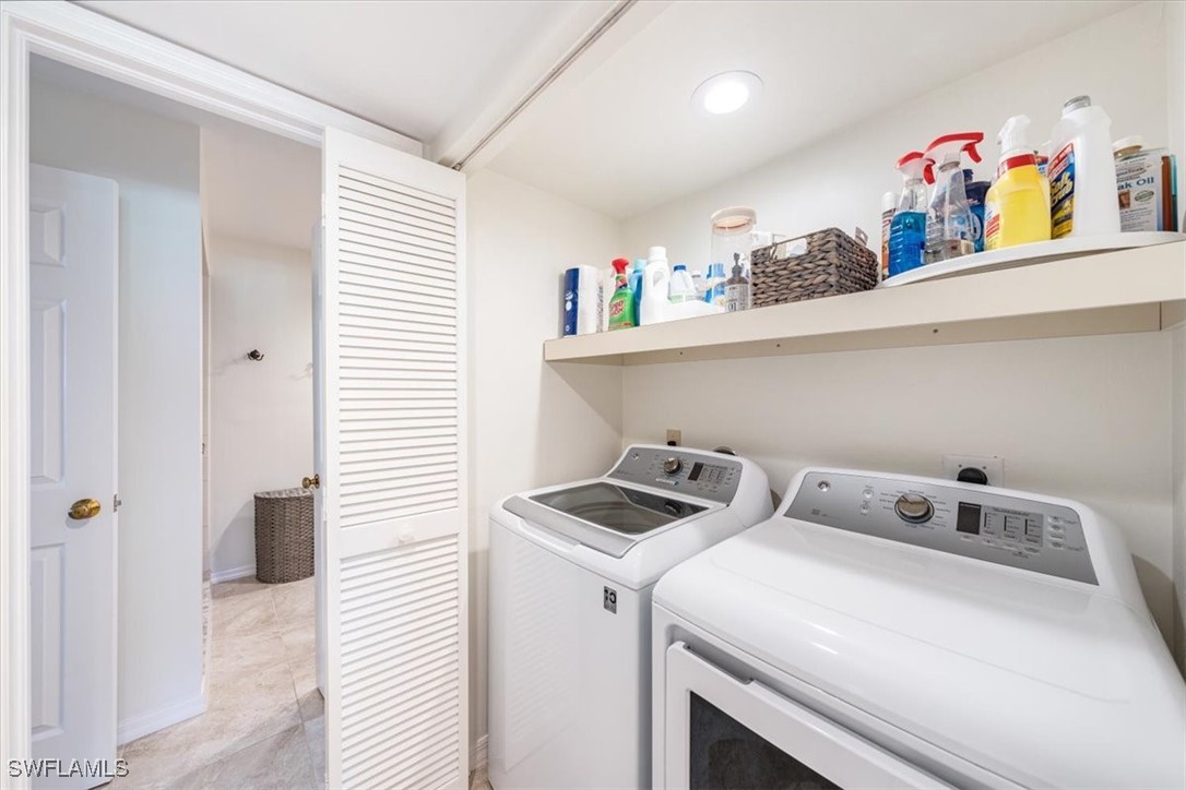 792 Eagle Creek Drive, Unit 101 Naples, FL 34113 - Photo 14 of 16 a utility room with dryer and washer