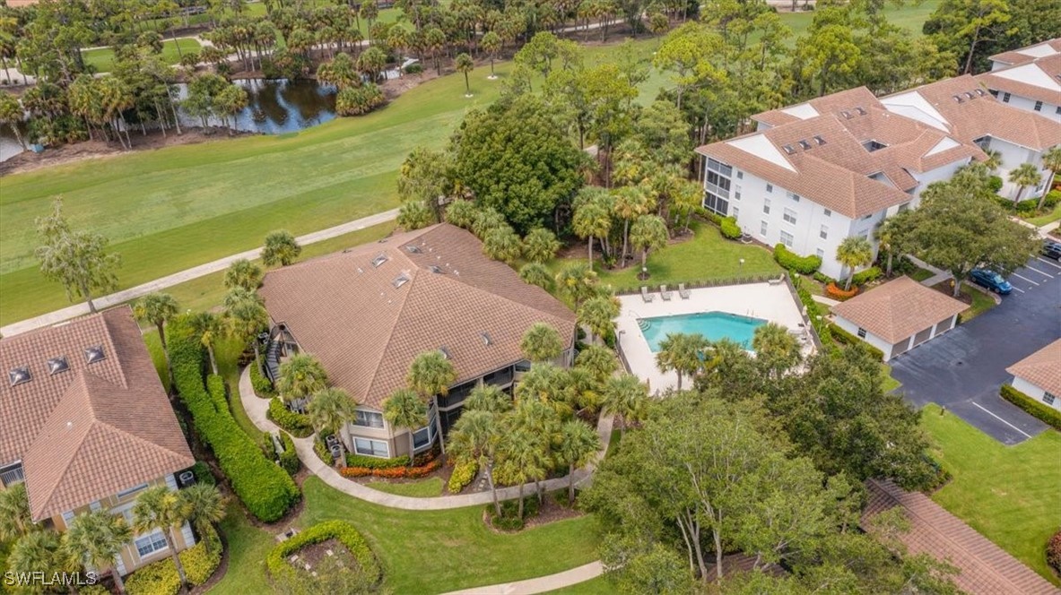 792 Eagle Creek Drive, Unit 101 Naples, FL 34113 - Photo 4 of 16 an aerial view of a house with a garden and lake view