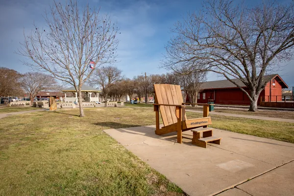 a view of a yard with wooden fence