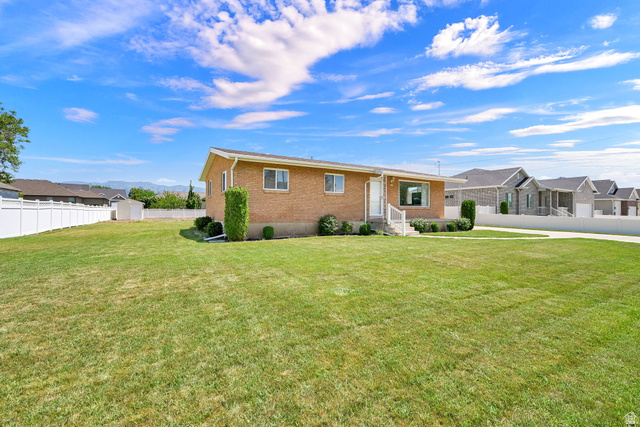 2467 South 2000 West Syracuse, UT 84075 - Photo 1 of 28 Spacious exterior with an expansive green lawn and a full vinyl fence