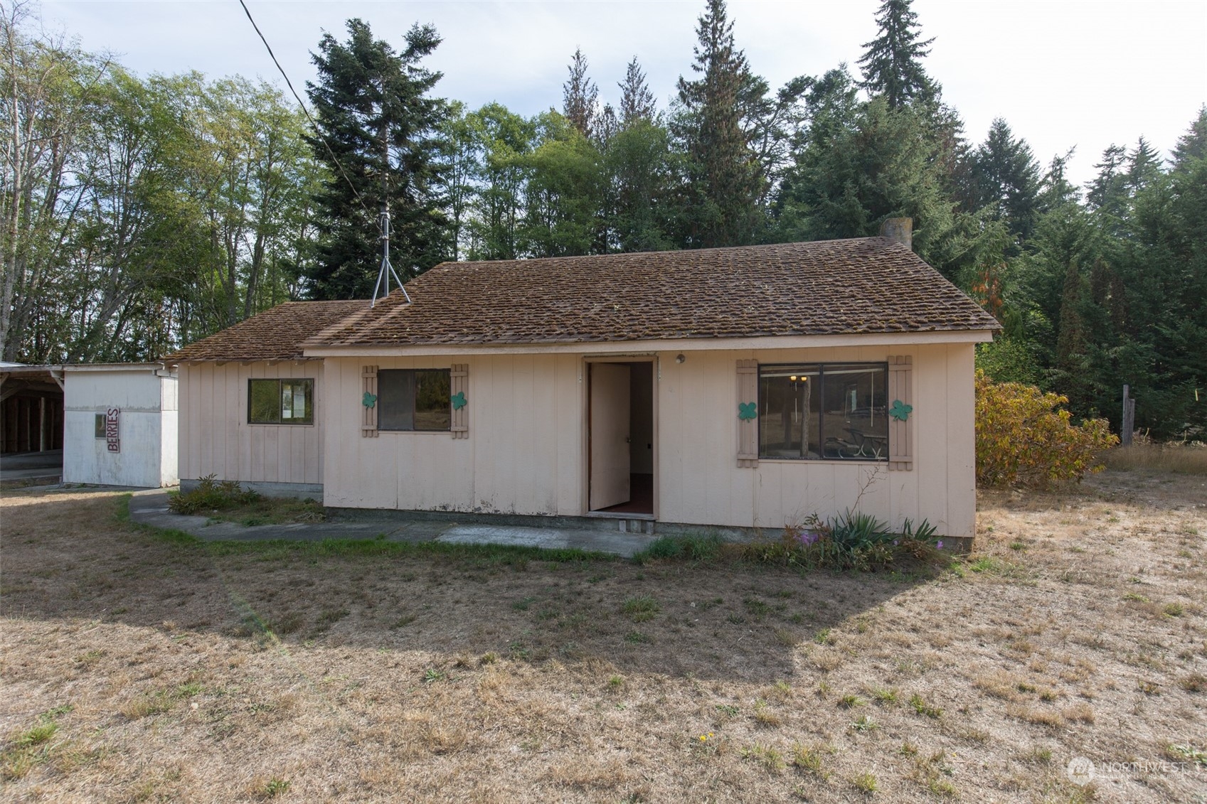 197 Jay Robinson Road Sequim, WA 98382 - Photo 1 of 40 a house that has a tree in front of it