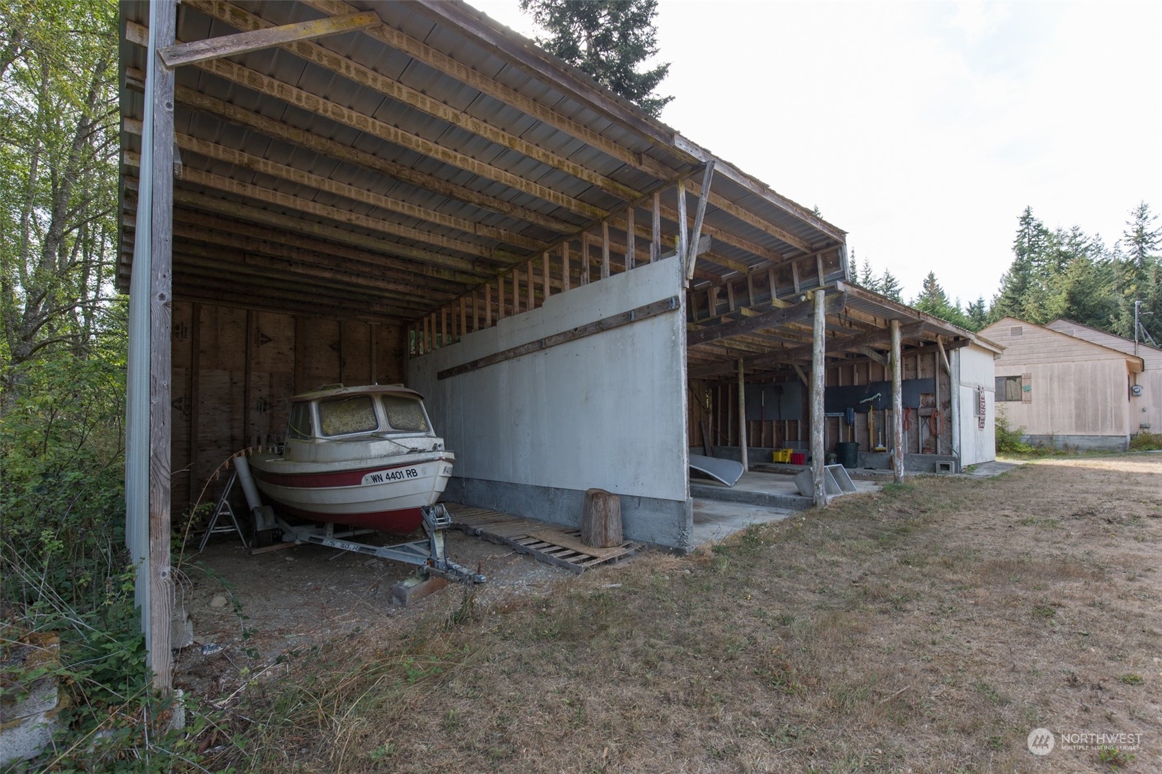 197 Jay Robinson Road Sequim, WA 98382 - Photo 14 of 40 a view of a backyard with table and chairs and wooden fence
