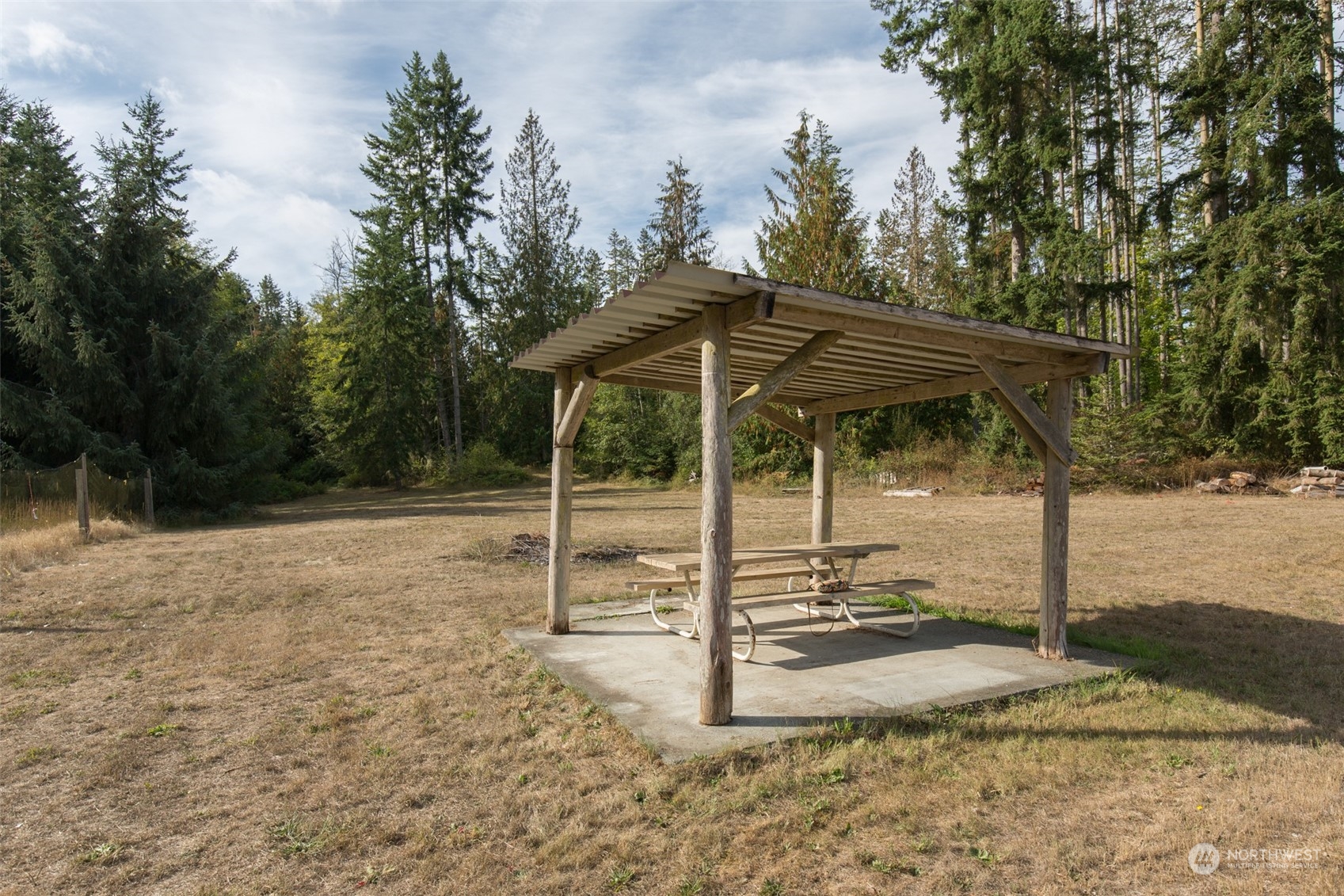 197 Jay Robinson Road Sequim, WA 98382 - Photo 23 of 40 a backyard of a house with table and chairs