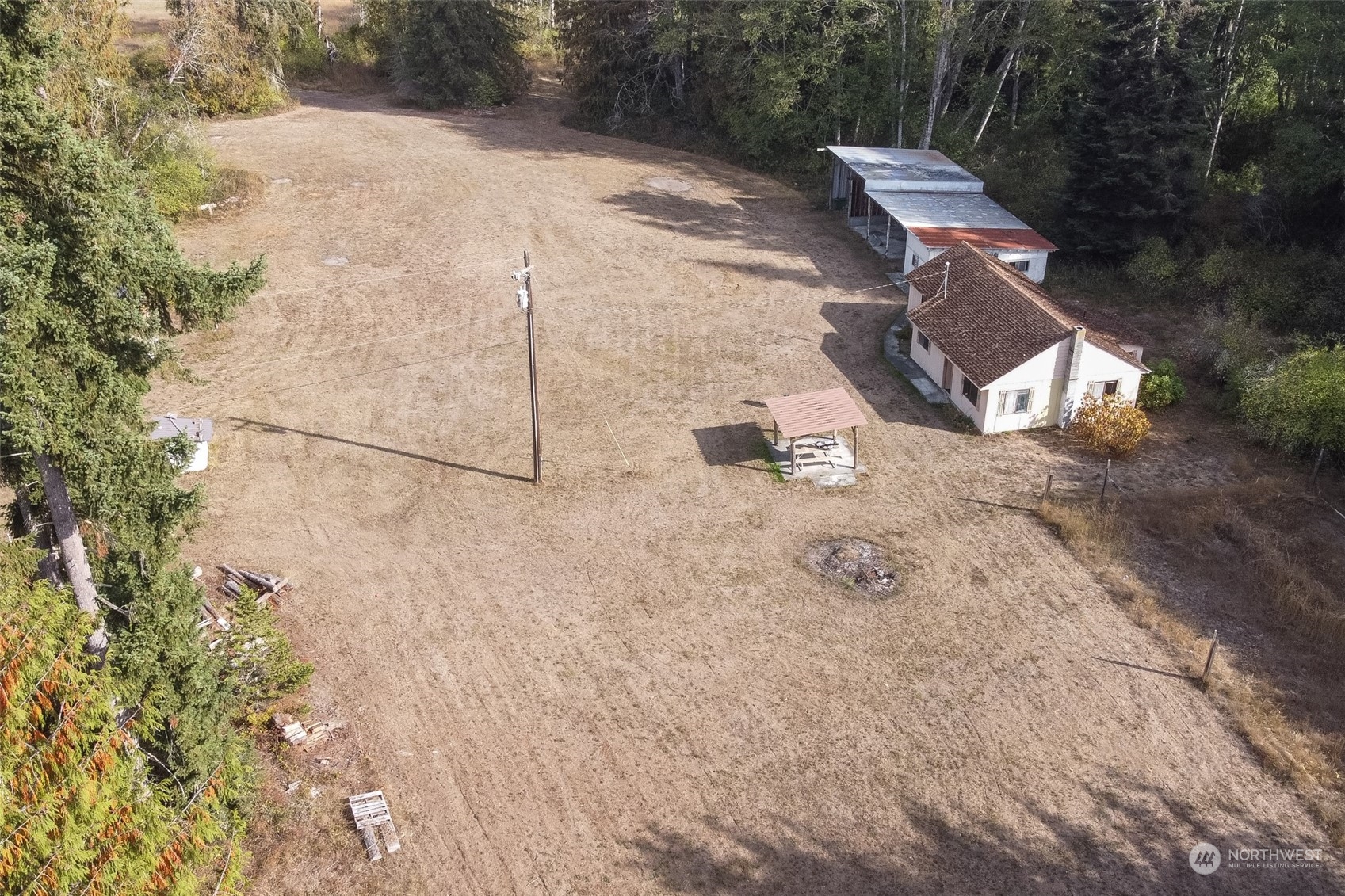 197 Jay Robinson Road Sequim, WA 98382 - Photo 25 of 40 a backyard of a house with table and chairs