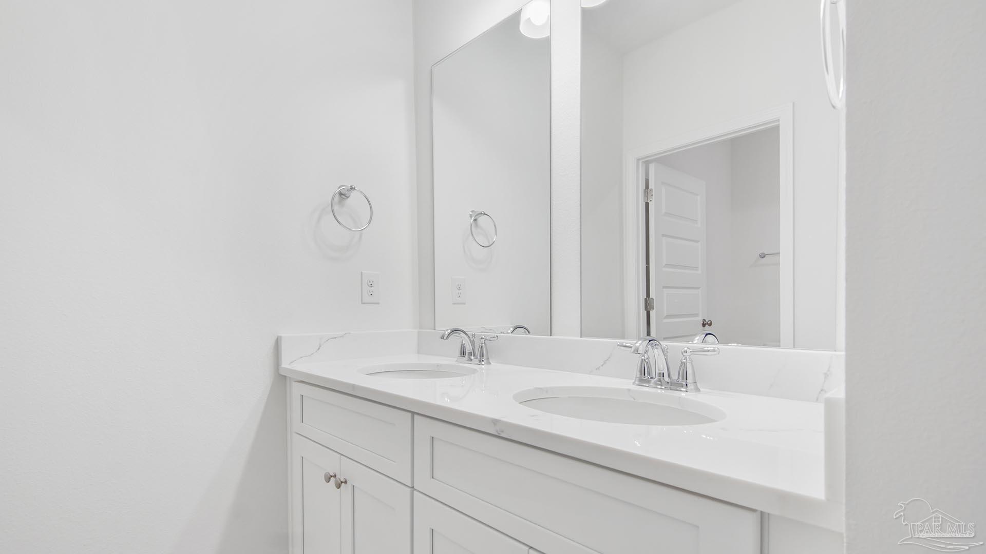 3233 Harrier Road Pace, FL 32571 - Photo 21 of 50 a bathroom with a sink and a mirror