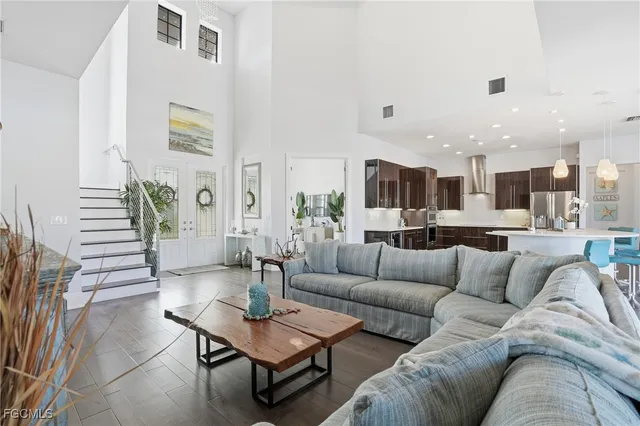 a living room with furniture kitchen view and a table