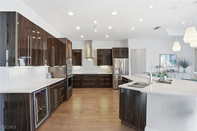 a large kitchen with kitchen island a sink stainless steel appliances and cabinets