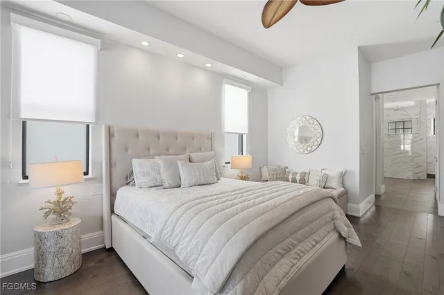 a bedroom with a bed and a large mirror