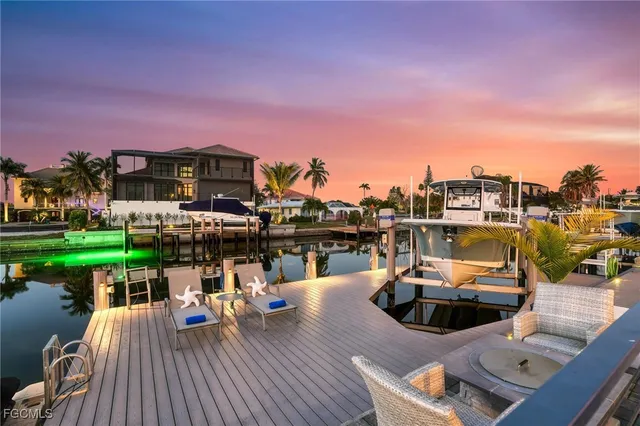 a view of a roof deck with table and chairs a fire pit and a lawn chairs