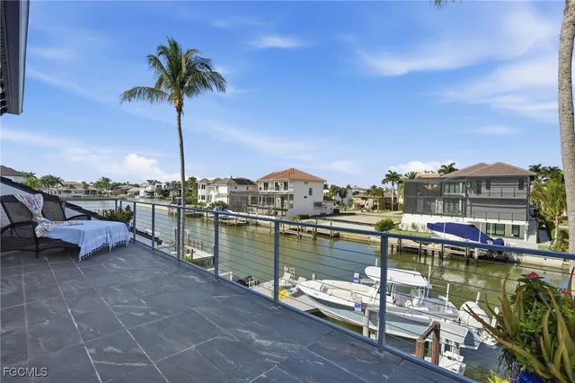 a view of a lake with a table and chairs