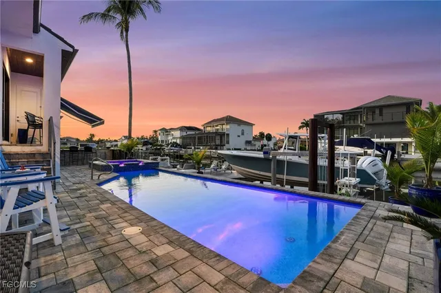 a view of a swimming pool with a lounge chair
