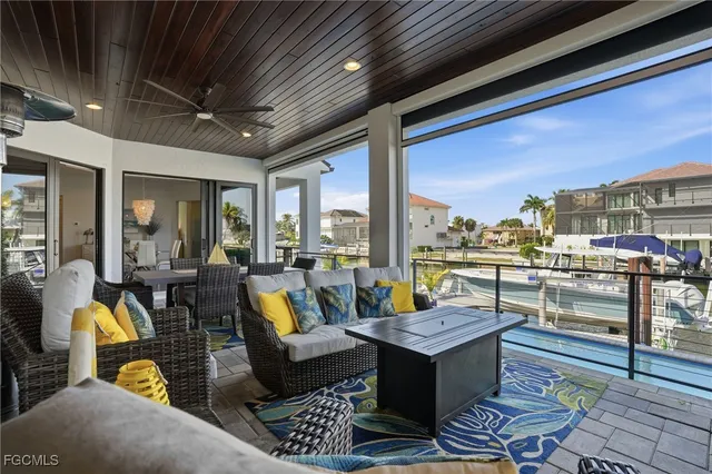 a living room with patio furniture and a floor to ceiling window