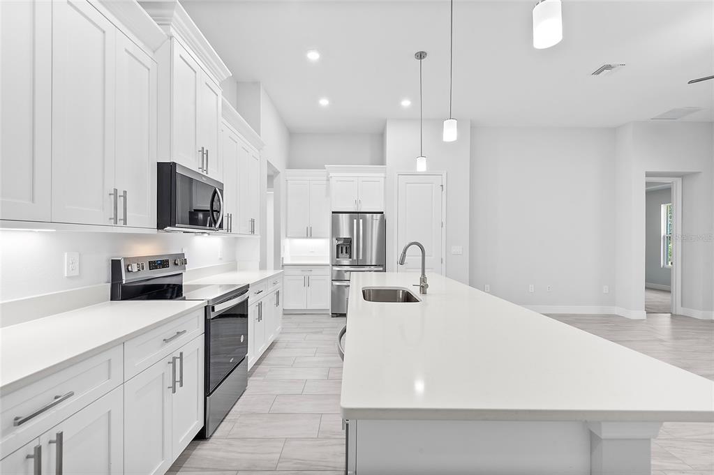 304 North Jungle Road Geneva, FL 32732 - Photo 12 of 49 a large white kitchen with stainless steel appliances