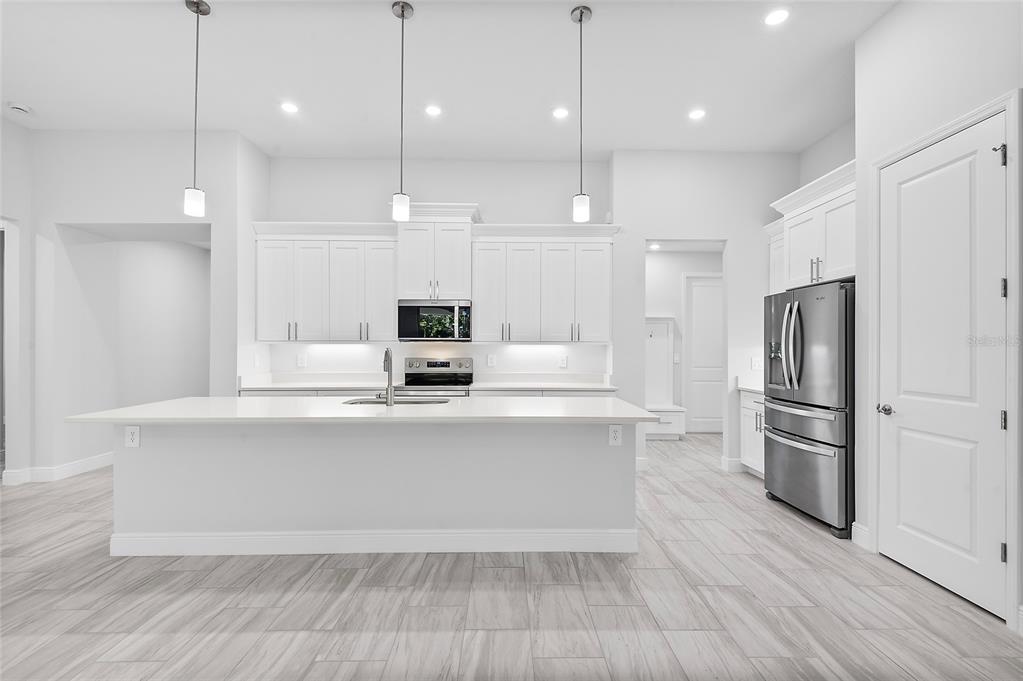 304 North Jungle Road Geneva, FL 32732 - Photo 13 of 49 a large kitchen with cabinets and stainless steel appliances