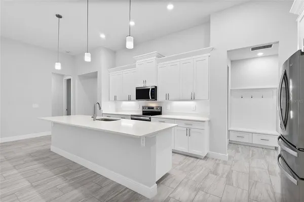 a kitchen with a sink stove and microwave