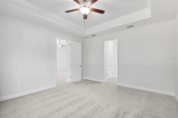 a kitchen with white cabinets and a window